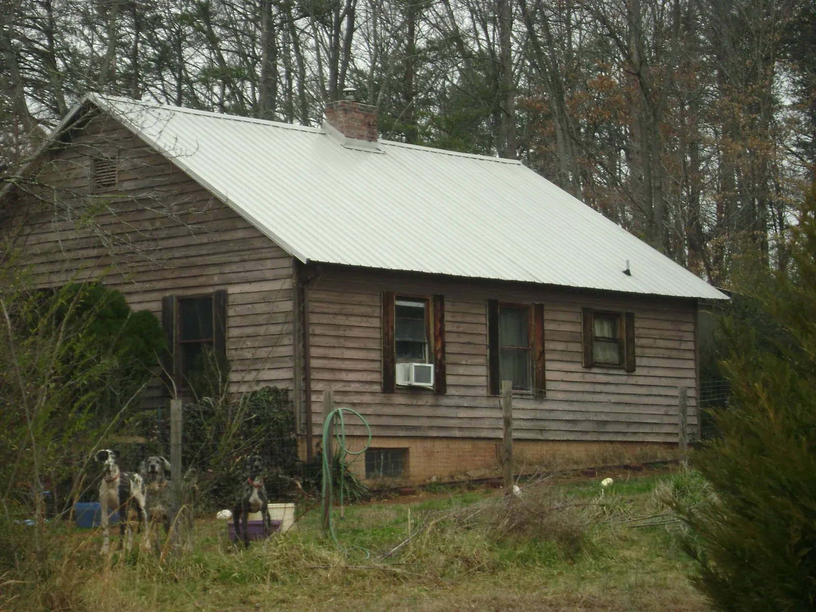 White metal roof on an old wood sided farmhouse, from a Asphalt Shingle Roof Repair job in Martinsburg